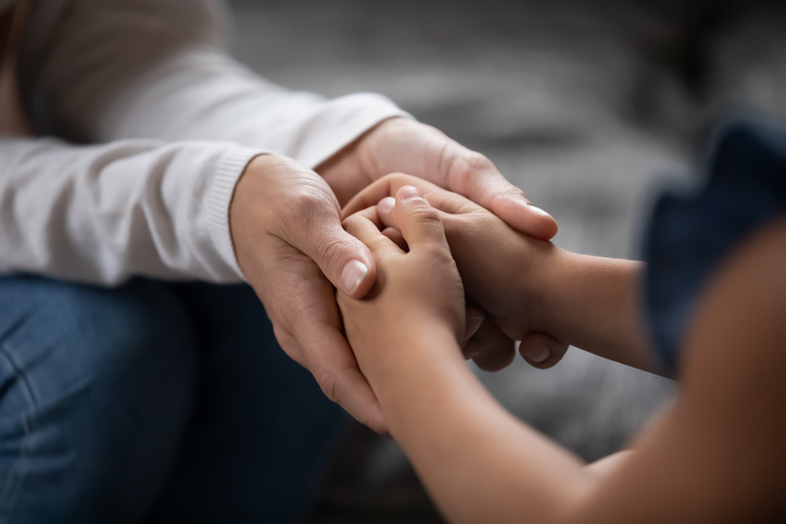 mother holding child's hands