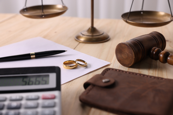 calculator, wedding rings, and a wallet in law office