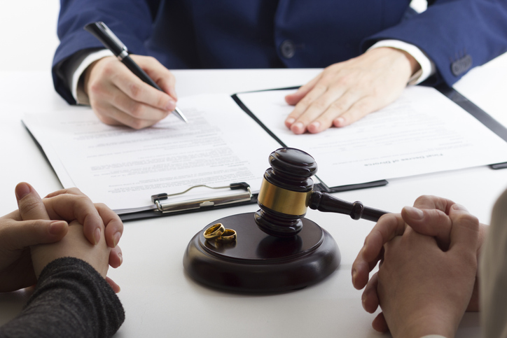 couple going through a divorce meets with a lawyer