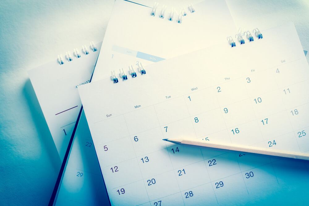 calendars on table with a pencil