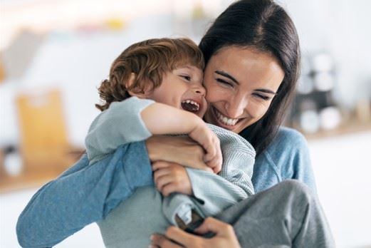 mother playing with laughing child